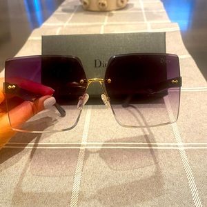 Rimless sunglasses in a purplish ombré finish, charcoal frame. Dior